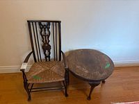 Armchair next to round side table showing overall design and relative size