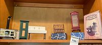 Shelf view showing all miniature furniture pieces and boxed kit