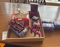 Tray showing cabinet, sleigh bench, three chairs, bathroom fixtures and boxed items