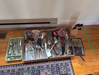 Wide view of entire lot showing flatware, utensils, knife blocks, trays, coasters