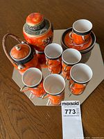 Full view of teapot, sugar bowl, six cups and six saucers