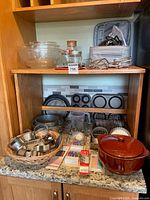 overall shelf with mixer, bakeware, bowls, casserole, cutters, candles