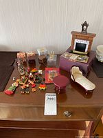 Overview of all miniature furniture, holiday items, toy train, boxed pieces on table