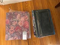 Stack showing floral scrapbook and multiple green photo albums