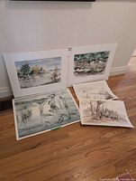 Four unframed T. Kenworthy Easson watercolour landscapes laid on floor