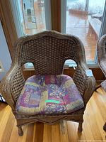 Front view of wicker armchair with cushion in place