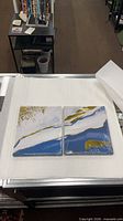 both sealed canvases side by side on table