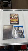 Overview of three movie discs: Robocop, Robocop Unrated Director’s Cut steelbook, The Rundown