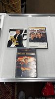 Front covers of three DVD cases arranged on table