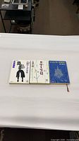 All three Japanese paperback books laid flat