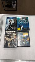 Front view of four DVD cases: Miami Vice movie, Miami Vice Season Two, Jarhead, Midway
