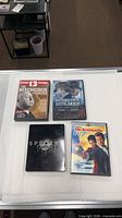 Four DVD cases laid out: Hitchcock Collection, Sherlock Holmes, Spectre 007, Die Another Day 007