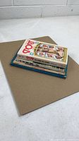 Stack of four vintage baseball books, side view