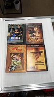 All four DVD cases displayed face up on table