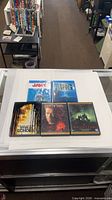 Top view of five horror DVDs arranged on display counter