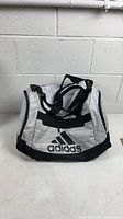 Front view of gray and black Adidas duffel gym bag showing logo and overall design