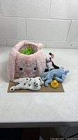 overall lot showing basket, grass, three Beanie Babies, rubber duck