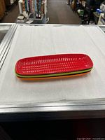 Three stacked coloured corn dishes
