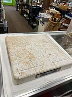 Top view of game-used base showing dirt stains, embossed branding and texture