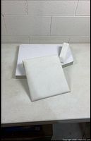 All three white jewelry display pieces laid out: riser base, square pad, narrow stand