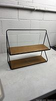 Full view of shelf showing two tiers and metal frame