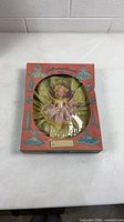 Front view of boxed doll