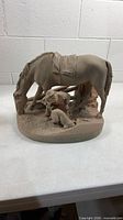 Front view of John Rogers plaster statue showing farmer, horse and dog on oval base