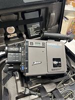 Camcorder, power adapter and cable inside case