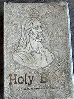 Front cover showing embossed Christ image and gold title