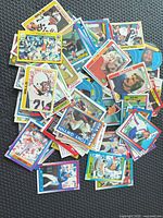 Pile of assorted baseball and football trading cards showing quantity and mix