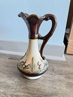 Full view of pitcher showing form, glaze and painted cactus motif