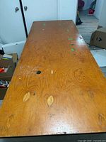 Top view of full table showing veneer surface, grommet holes, wear