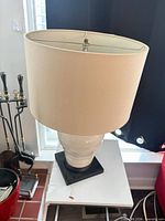 Full view of lamp with shade on side table