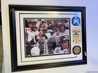Front view of framed Colorado Avalanche 2001 Stanley Cup champions memorabilia with photo, plaque, medallion and net fragment