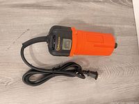 Top view of orange and black Dewoxx corded rotary tool showing full body and power cord