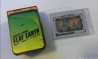 Front view of Escape From Flat Earth game box and Allen & Ginter trading card in sleeve