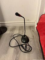 Microphone on base with coiled XLR cable visible