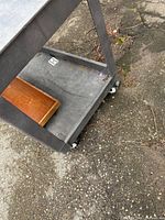 close lower corner highlighting casters and wear
