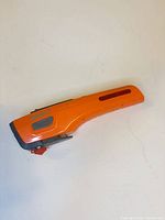 Full view of orange Helwin 7 flashlight