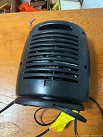 Rear/top view displaying vent slats and handle