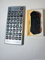 Innovage jumbo remote and Fosmon keyboard box side by side