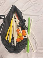 Open bag showing mixed color poles, connectors, bolas