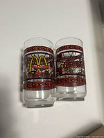 Pair of glasses front view showing logos and stained-glass graphics