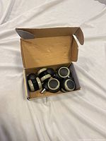 Open box displaying five caster wheels inside
