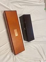 Top view of both closed cases, showing cherry and espresso finishes and label plate