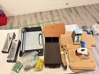 Entire lot overview showing scale, tape dispenser, paper cutter, organizers, cardboard mailers and consumables