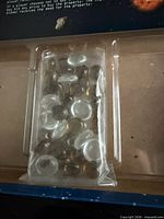 sealed bag of clear and grey coin tokens