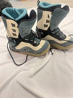 Side view of both snowboard boots showing colour scheme, materials and wear