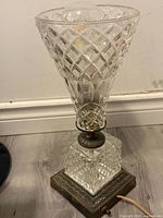 Full view of crystal cut glass lamp on metal base