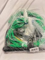 Angled view of rope coiled around handle inside plastic wrap